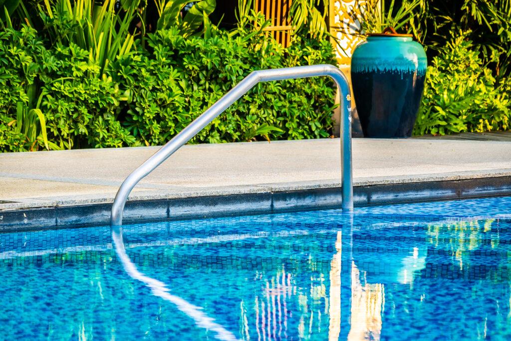 beautiful outdoor swimming pool with bed deck chair and umbrella